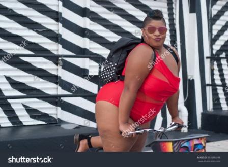 stock-photo-plus-size-woman-in-a-red-piece-bikini-on-a-bike-655606048.jpg